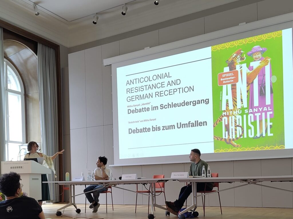 a photo of Leila Essa giving a presentation at the "For Now" conference